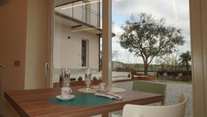 a wooden table with chairs and a dining room at Casa Panerole in Novello