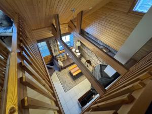 an overhead view of a living room with wooden ceilings at Usva Cabins Ylläs - Sapara J 38 in Äkäslompolo