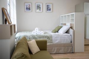a bedroom with a bed and a couch at Apartament Daisy II Pszczyna Centrum in Pszczyna
