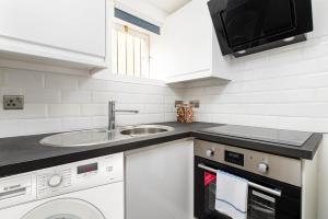 a kitchen with a sink and a dishwasher at Central Basement Flat-Parking-By FabAccommodation in Bristol
