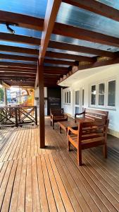 two benches sitting on a wooden deck at Pousada Ruppenthal in Canela