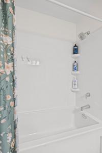 a bathroom with a tub and a shower curtain at 3 Bedroom suite Upper Level of House 8 guests in Barrie +54 photos