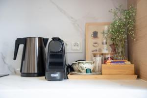 a coffeemaker sitting on a shelf with a coffee maker and a coffee pot at Apartament Daisy II Pszczyna Centrum in Pszczyna