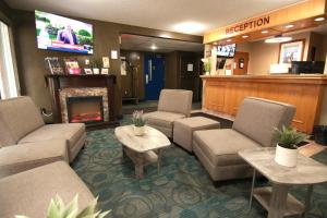a waiting room with couches and a fireplace in a hospital at Colonial Inn in Brandon
