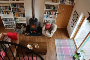 an aerial view of a living room with a wood stove at Modern, eco friendly house in Kildonan on Skye in Flashader