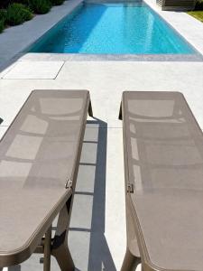 a table and chair next to a swimming pool at Beach SUN and FUN in Podersdorf am See