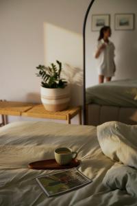 a tray with a cup of coffee on top of a bed at Maison C in Nice +31 photos