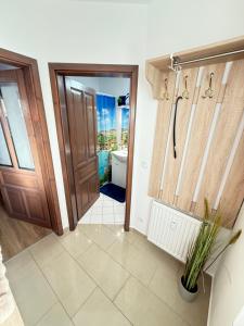 a bathroom with a toilet and a door at Thermal Oazis Apartman in Mosonmagyaróvár +18 photos