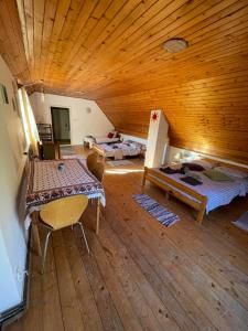 a room with two beds and a wooden ceiling at Casa Dalia 2 in Sighişoara