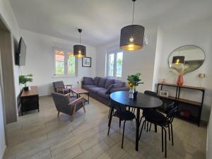 a living room with a couch and a table and chairs at Summer house Le Vito in Tribunj