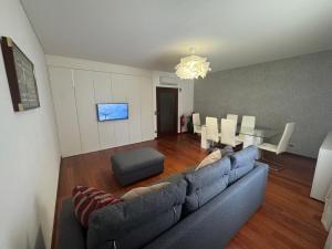 a living room with a couch and a dining room at Vila Praia House in Vila Praia de Âncora