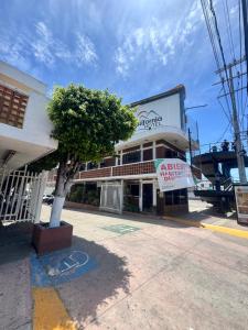 a building with a tree in front of it at Hotel California in Mazatlán