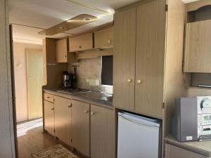 a kitchen with wooden cabinets and a stove top oven at het straatje in Scherpenisse