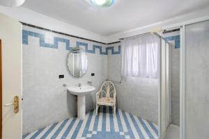 a bathroom with a sink and a mirror and a shower at B&B H Pompeii Ruins in Pompei +26 photos