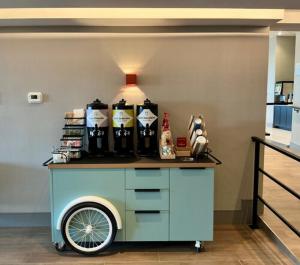 a cart with bottles on top of it in a room at Spark by Hilton Montreal Brossard in Brossard