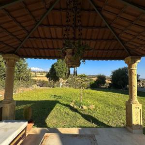 a porch with a view of a field of grass at Dar Kmaar in Hammamet