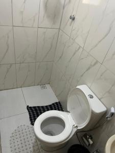 a bathroom with a white toilet and a sink at Cantinho da Naná in Cavalcante +14 photos