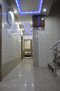 a room with a hallway with a blue light on the ceiling at Hotel Haji Ali - Sahil inn in Ajmer