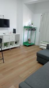 a living room with a couch and a tv at Anna Home in Telde