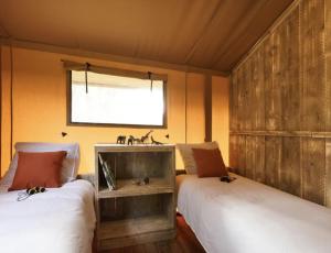 two beds in a small room with a sink at F1 Group Stay Close to Track Parking Grumpy in Amblève