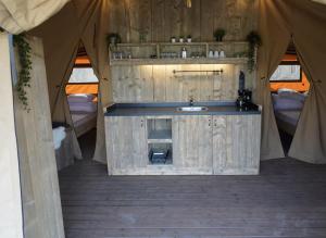 a bathroom in a tent with a sink in it at F1 Group Stay Close to Track Parking Grumpy in Amblève