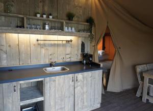 a bathroom with a sink and a tent at F1 Group Stay Close to Track Parking Grumpy in Amblève +37 photos