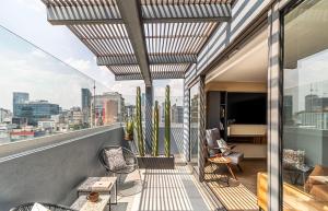 a balcony with a view of a city at Kukun Tonala 30 Roma in Mexico City +18 photos