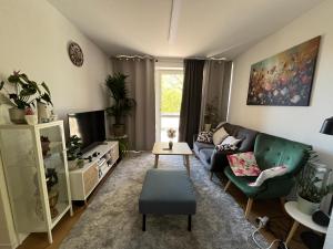 a living room with a couch and a tv at Private Room in Oldenburg with Balcony in Shared Apartment in Hundsmühlerhöhe