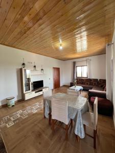 a living room with a table and a couch at Bert-House close to the sea in Lezhë