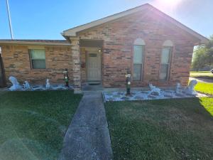 a brick house with white statues in front of it at Great location to explore Houston in Houston