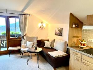 a living room with a couch and a table at Gästehaus Alpenruh in Fischen