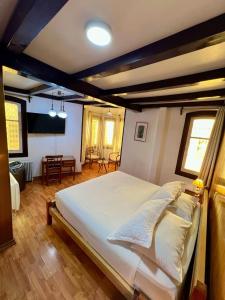 a bedroom with a large white bed in a room at Hotel Vegas in Santiago