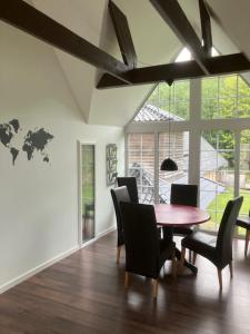 a dining room with a wooden table and chairs at Penthouse deluxe in Hobro