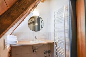 a bathroom with a sink and a mirror at Altes Schulhaus in Heiligenberg +51 photos
