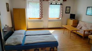 a living room with a bed and a table at Apartmán Andels I in Rakovník
