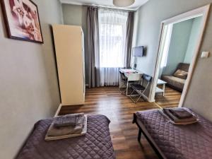 a small room with a bed and a living room at Villa Podkarpacka in Kudowa-Zdrój