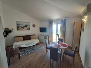 a living room with a couch and a table at Resort "Maslinjak" in Budva