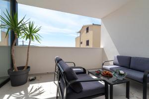 a living room with a couch and a table at Natura Vita Apartment-New Modern Apartment with City View & two Free Parking Spaces-10 min Walk to Trogir Old Town in Trogir