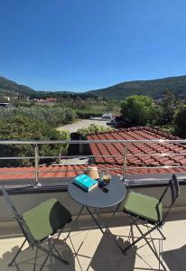 a table and two chairs sitting on a balcony at Villa Konalic in Mokošica +20 photos