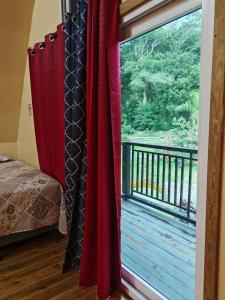 a room with a window with a view of a deck at Cabaña Bungalow in Tela
