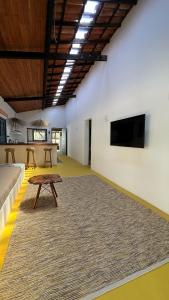 a large room with a couch and a table at Casa Pema - Grupo Casa Camurupim in Barra Grande