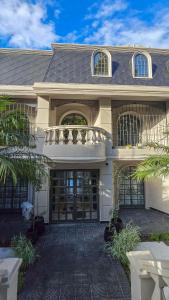 a large white house with a large door at Trento Hotel Boutique in San Salvador de Jujuy