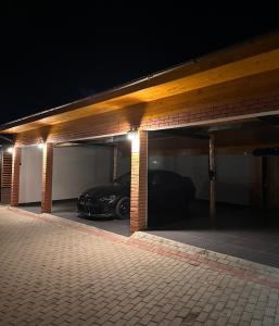 a garage with a car parked in it at night at Cabin&Villa Property in Târgu Ocna