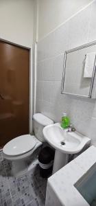 a bathroom with a toilet and a sink at María House in San Miguel