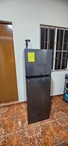 a refrigerator with a yellow sticker on it in a room at María House in San Miguel +4 photos