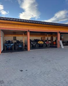 a group of motorcycles parked in a garage at Cabin&Villa Property in Târgu Ocna