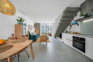 a kitchen and living room with a table and a dining room at The Blue House - Mediterranean Loft in Faro