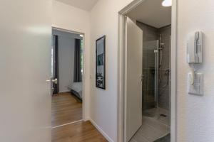 a bathroom with a walk in shower next to a glass door at Litzi's zentrales Apartment mit Parkplatz in Hockenheim +23 photos