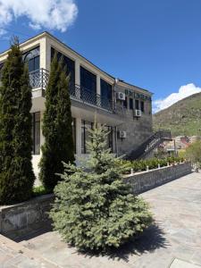a christmas tree in front of a building at Yolyans Hotel in Goris