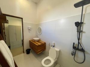 a bathroom with a toilet and a sink at Minah bungalows in Nungwi +14 photos